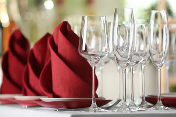 Table setting with empty glasses, plates and cutlery on table