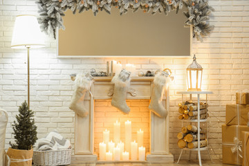 Room interior with mirror over fireplace decorated for Christmas