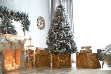 Stylish interior with decorated Christmas tree in living room
