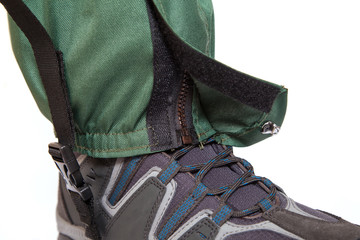giaters and hiking boot on white background