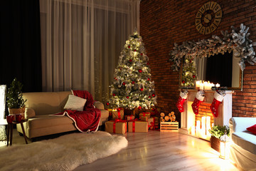 Fototapeta premium Stylish room interior with beautiful Christmas tree in evening