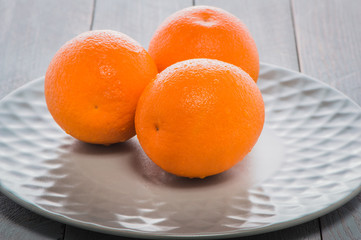 Fresh fruit oranges healthy food.fresh orange fruits with leaves in a basket on wooden table