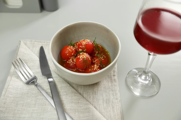 Tasty soup with blanched tomatoes and beer on light table