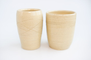 two beige vases on a white background. minimalism style. interior decoration.