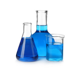 Laboratory glassware with blue liquids isolated on white
