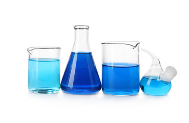 Laboratory glassware with blue liquids isolated on white