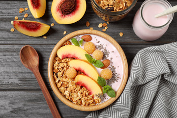Tasty homemade granola with yogurt on grey wooden table, flat lay. Healthy breakfast