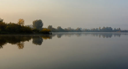 Naklejka na ściany i meble Morning fog on the river. Autumn