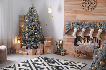 Stylish room interior with beautiful Christmas tree and decorative fireplace