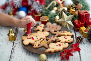 Preparing traditional gingerbread cookies with ornaments for new year celebration
