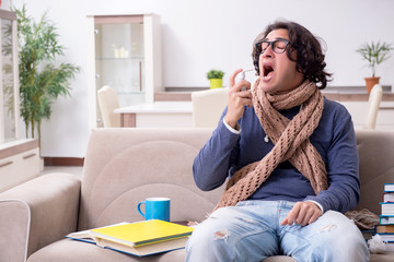 Sick male student suffering at home