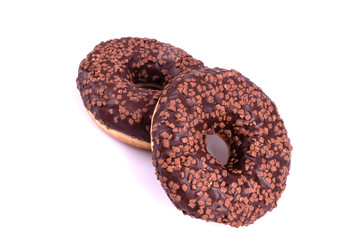 donut-shaped chocolate donuts with a hole in the middle are glazed and decorated with powder depicted on a white background