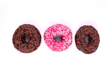 one donut, covered with pink icing in the center, two chocolate on the sides, shown in close-up, on a white background.