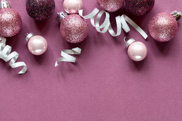 Fototapeta na wymiar Lilac christmas background with christmas balls and festive. Flat lay