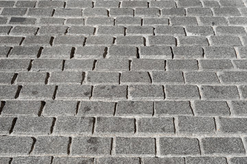 Fondo de pavimento empedrado de adoquines de granito en perspectiva