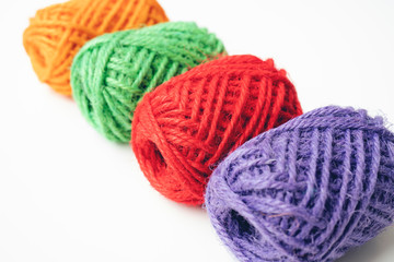 Colorful yarn balls as isolated white background, close up