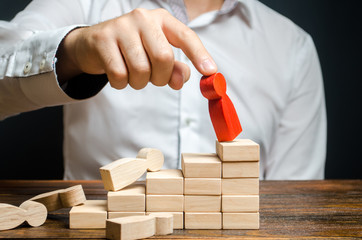 A man removes the red figure of a man from the career ladder. Poor business management. employee...