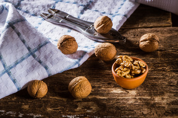 Whole walnuts on a plate.Whole walnuts on rustic old wooden table.Trace elements zinc, magnesium, healthy food.