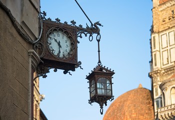 Fototapeta na wymiar Ornate Wrought Iron Clock and Lamp