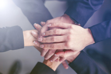 Creative team putting their hands together in circle