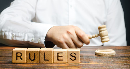 A man knocks a hammer publishes new rules and laws. Setting clear rule and restrictions. Leadership...