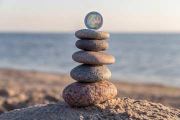 2 EUR coin and pebble