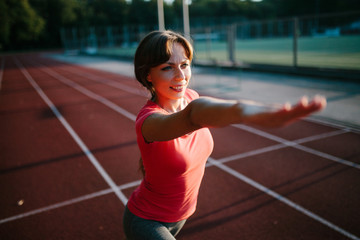 Obraz premium Young beautiful woman practicing yoga in the stadium. Relax