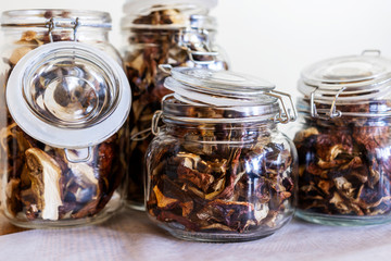 Fall harvests. Dried boletus in the jars - ECO autumn forest goodies. Mushroom drying. Fall season background.