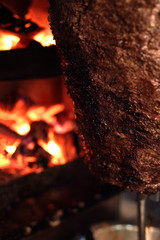 Close up shot of stacked meat roasting to be used in preparation of traditional Greek dish gyros or...