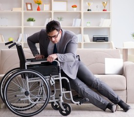 Obraz premium Dsabled businessman on wheelchair working home