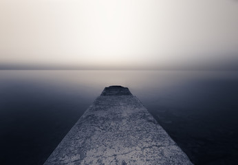 Perspective Cement pier with beautiful sea nature background. Abstract long exposure photography...