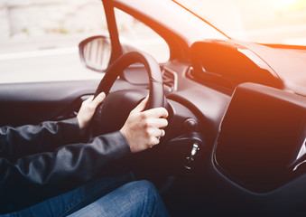 Young woman driving car, hand hold steering wheel. Secure driving concept