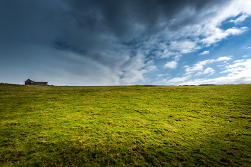 wide open landscape with old wooden barn