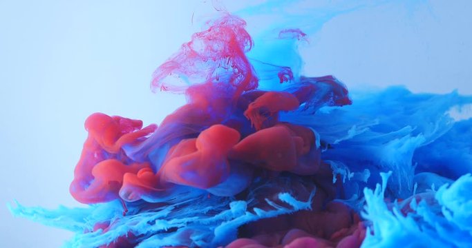 Macro shot of red and blue ink in a swirl tank