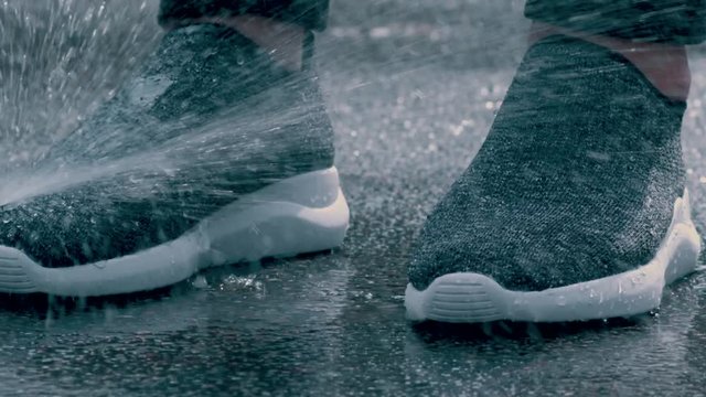 guy testing water-repellent sneakers close-up