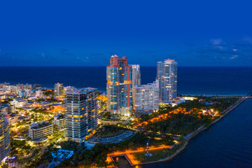 Fototapeta na wymiar Aerial night photo Miami Beach condominiums illuminated South Pointe Park scene