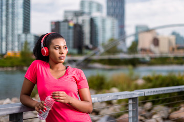 Beautiful woman running, stretching and exercising in urban environment