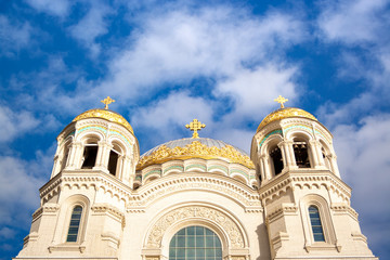 Fototapeta premium Nicholas the wonderworker's church on Anchor square in kronstadt town Saint Petersburg. Naval christian cathedral church in russia with golden dome, unesco architecture at sunny day