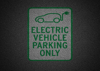 Electric vehicle charging station sign on asphalt. High Quality asphalt texture background.
