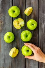 Autumn composition with green apple on dark wooden background top view