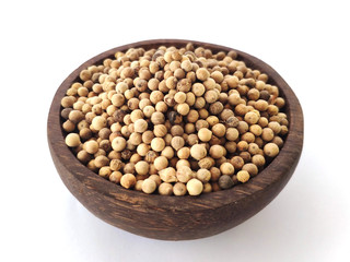 Piper Albi Linn / White Pepper (known as Lada or Merica Putih in Indonesia) on a wooden bowl at white background