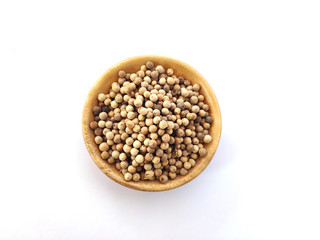 Piper Albi Linn / White Pepper (known as Lada or Merica Putih in Indonesia) on a wooden bowl at white background