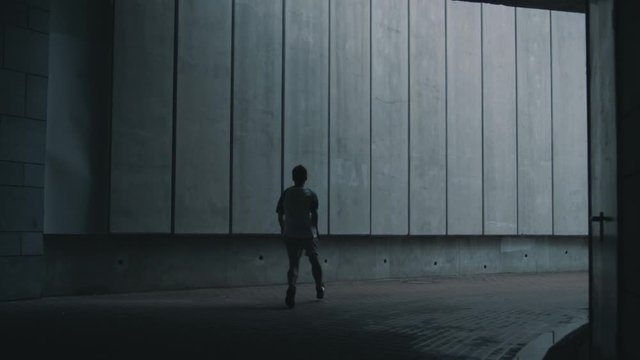 the guy is doing parkour in urban place