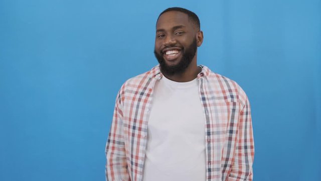 Say hello! A friendly black man waves affably at the camera. 4K