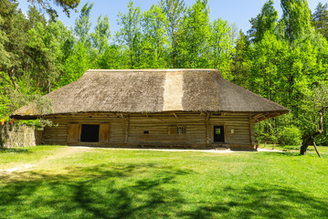 Fototapeta na wymiar Vintage countryside log house with the yard on a sunny summer day.