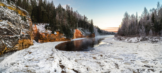 Aerial view of river with floating ice in cold winter. River Gauja, Latvia.