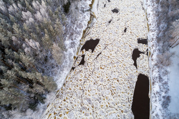Aerial view of river with floating ice in cold winter. River Gauja, Latvia.