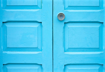 Blue door detail with a knob.