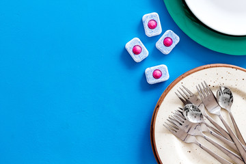 Detergent for washing dishes on blue background top view space for text