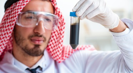 Arab chemist scientist testing quality of oil petrol